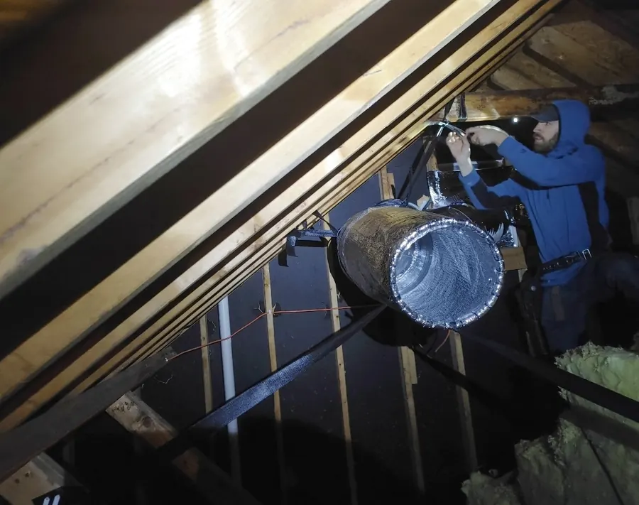 Installer setting up an Attic Torpedo in an attic